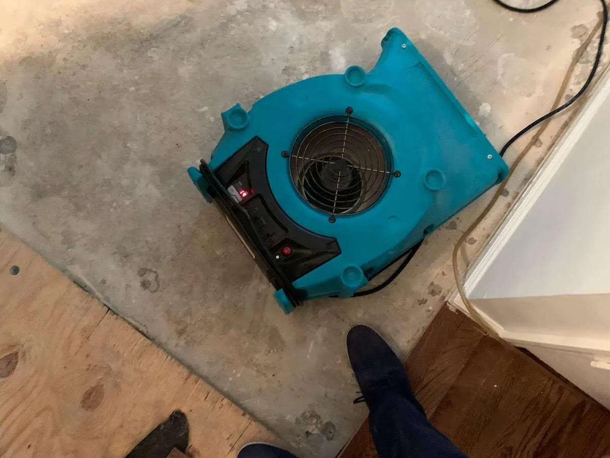 Air mover drying subfloor during Commercial Water Damage Restoration in Lower Merion